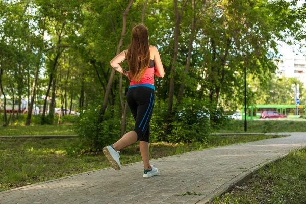 Running woman in park in summer training