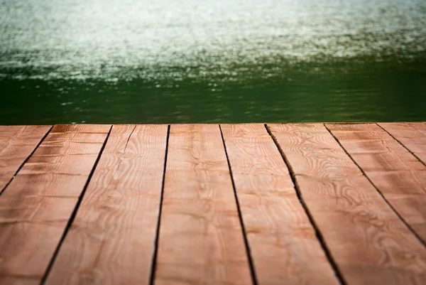 Edge of wood deck near water