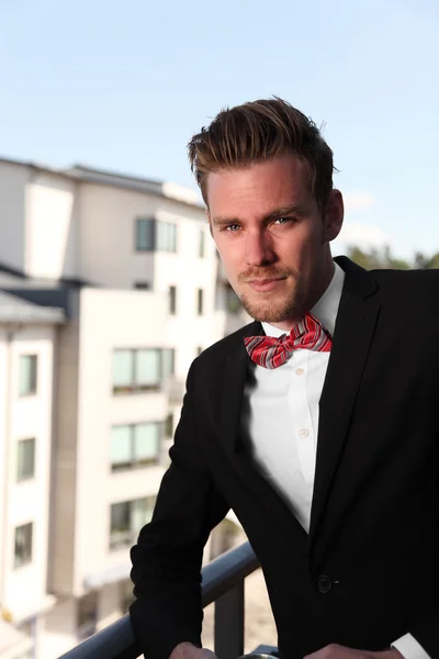 Attractive man standing wearing a black jacket