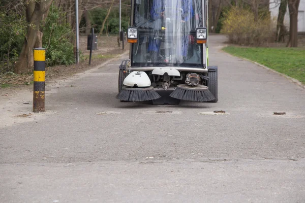 SWEEPER CAR IN A CITY PARK ,CLEANING
