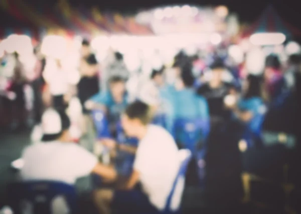 Festival event with blurred people background