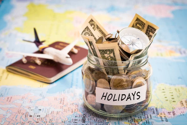 Holidays budget concept with compass, passport and aircraft toy