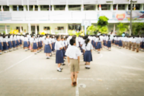Blurred schoolchild standing in row in school