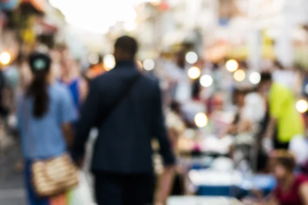 Blurred people walking on the street