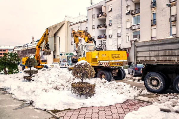 METKOVIC, CROATIA - FEBRUARY 10: Excavator cleans the streets of large amounts of snow in Metkovic, Croatia on February 10, 2012.