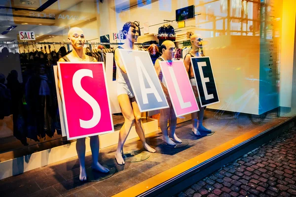 Shop window with funny mannequins announce sale in Copenhagen, Denmark