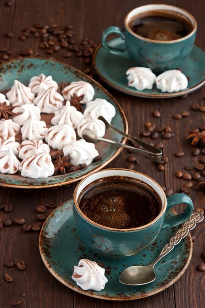 Cup of coffee with meringue cake