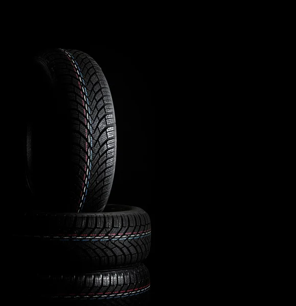 Car tires. Winter wheel profile structure on black background