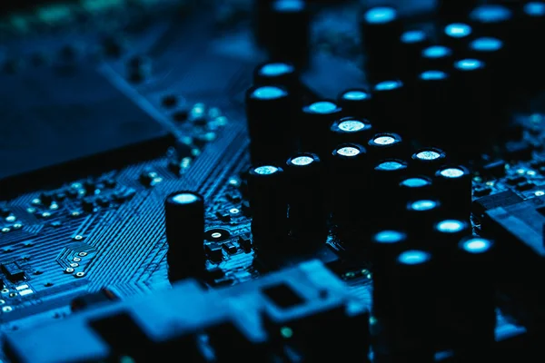 Computer motherboard closeup blue color on dark background