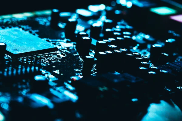 Computer motherboard in blue dark background close-up