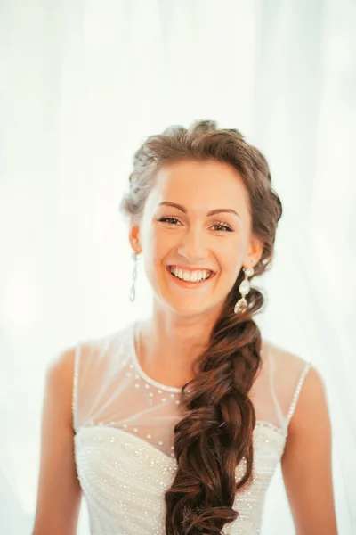 Beautiful young bride with wedding makeup and hairstyle in bedroom, newlywed woman final preparation for wedding. Happy Bride waiting groom. Marriage Wedding day moment. portrait soft focus
