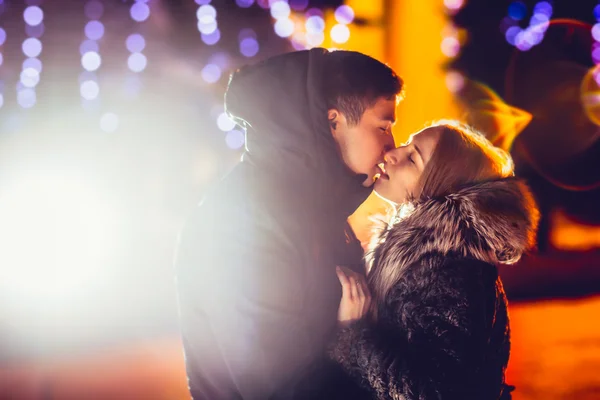 Young couple in love  outdoor filtered photo with flash flare