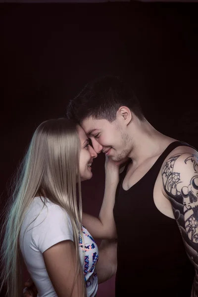 Shot of a passionate loving couple. Over black background.