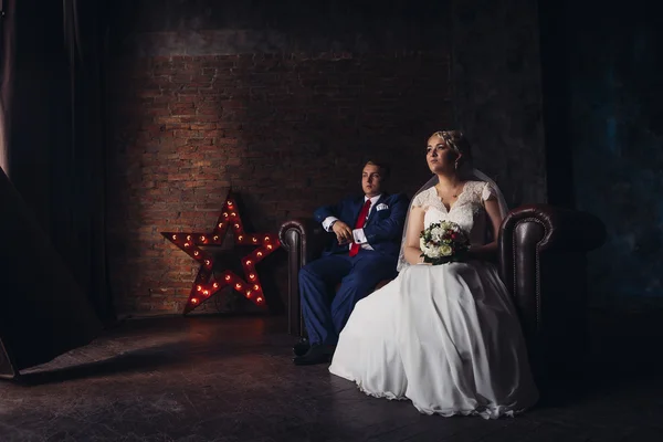 Beautiful young couple suit on a dark background