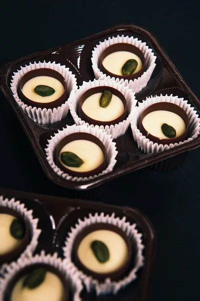 Many chocolate sweets with  Pistachio on black background