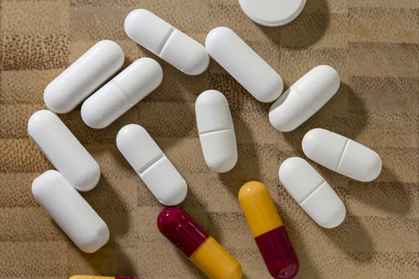 Many painkiller pills on a textured background