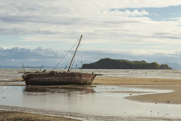 Stranded boat on a low tide beach in Madagascar