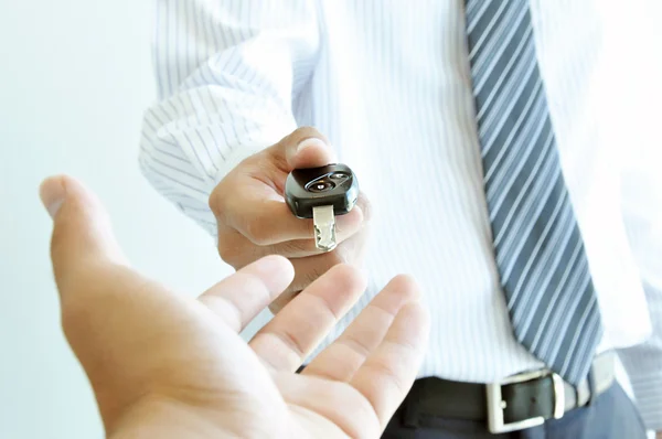 A man giving a car key