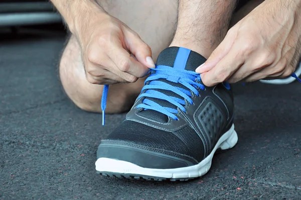 Hands tying sports shoe