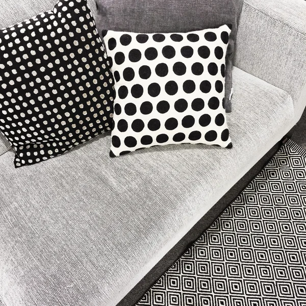 Black and white polka dot cushions on a sofa