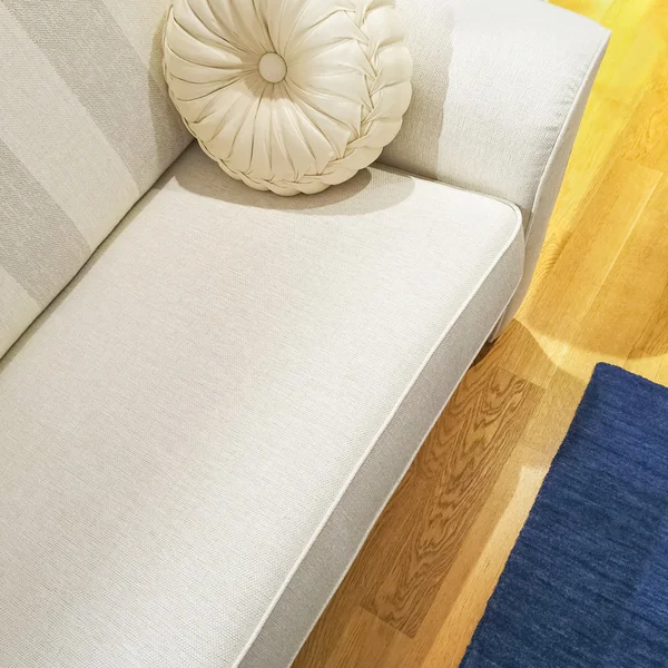 White sofa with a fancy cushion