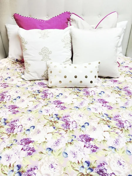 White and purple bed linen with floral design