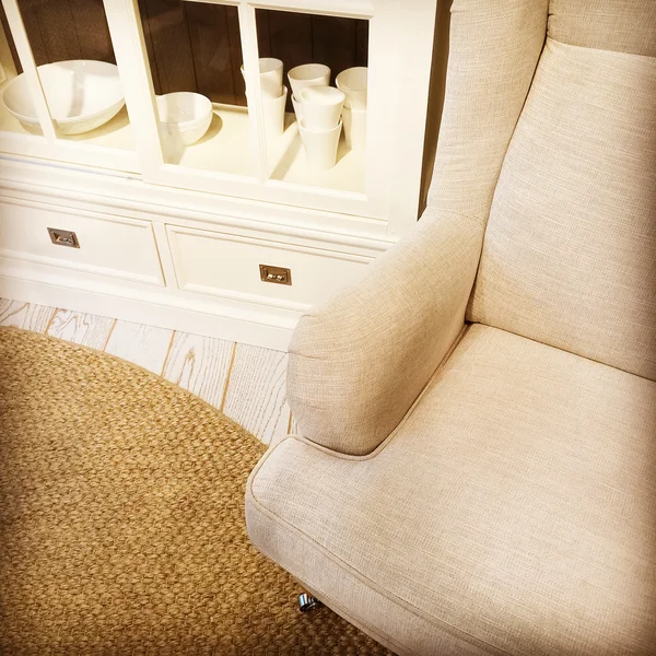 Detail of a living room with armchair and sideboard