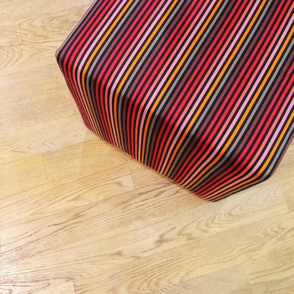Striped cube chair on wooden floor