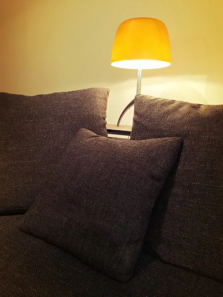 Cozy orange lamp and comfortable sofa