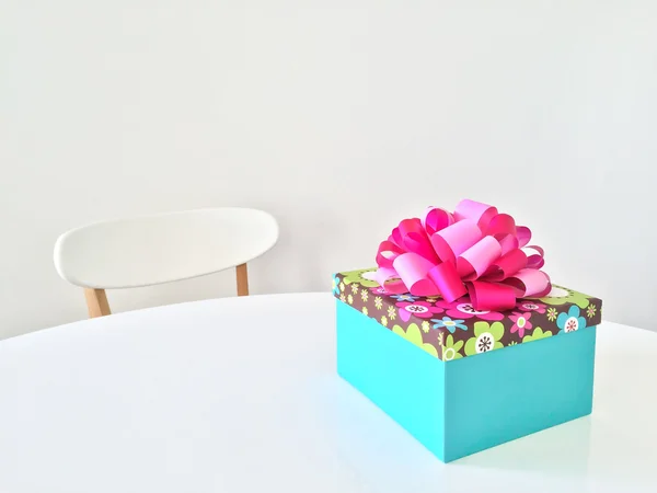 Bright gift box on white table