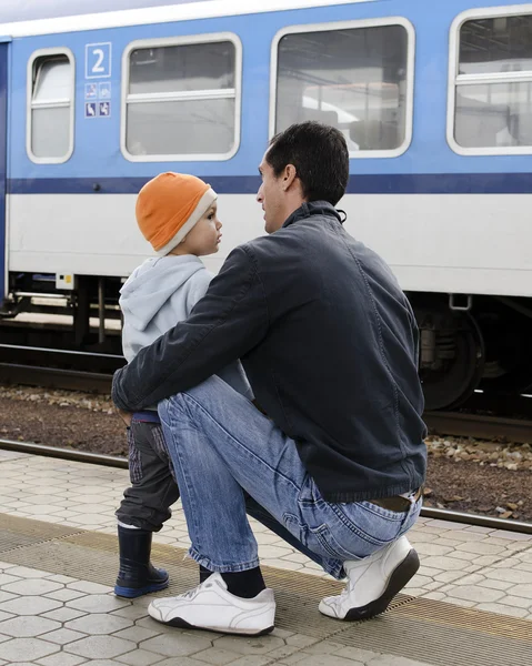 Father and son at train station