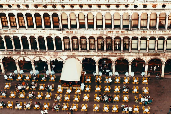 Venice, Italy - November 28, 2014: Yellow Chairs and Round Tables Aerial View on Famous Saint Mark\'s Square in Venice, Italy