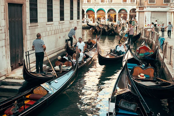 Venice, Italy - October 28, 2014: Gondolier on a gondola ride tourists on the water in Venice