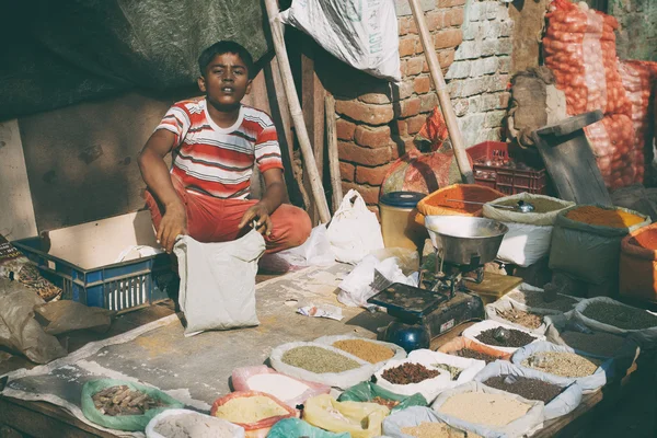 Indian boy selling spices