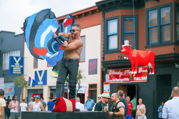 Unidentified people at the annual gay festival Folsom Street Fair in San Francisco, everyone is happy, having fun, and wear Carnival clothing