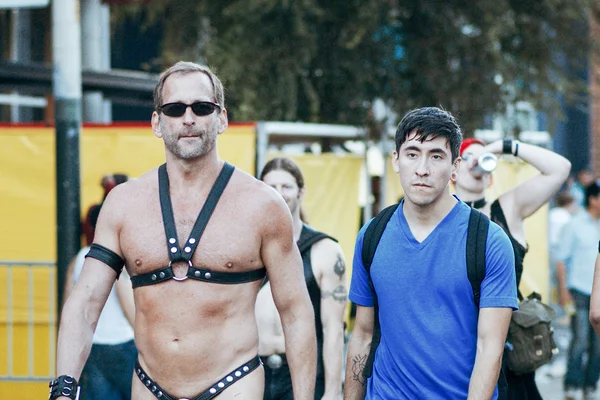Unidentified people at the annual gay festival Folsom Street Fair in San Francisco, everyone is happy, having fun, and wear Carnival clothing