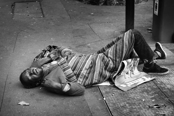 Man sleeping on the street in Paris, Homelessness in EU reached 3 million people in 2004. Globally about 100 million people live on the street. Black and white.