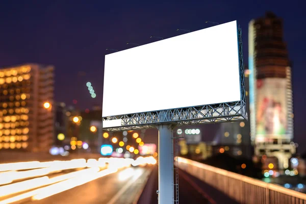 Blank billboard near expressway at night for advertisement.