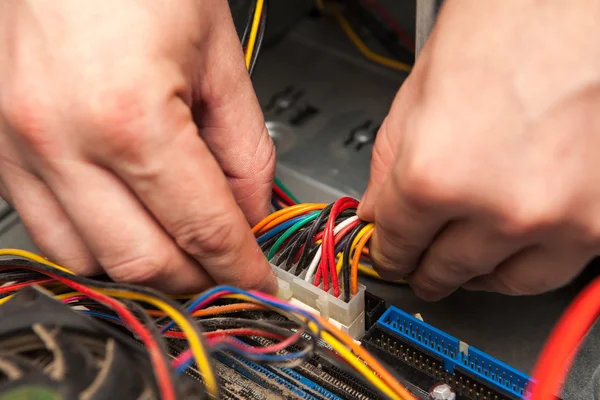 A technician stuck in the motherboard power cable.