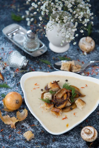 Bowl of cream mushroom soup with fried mushrooms