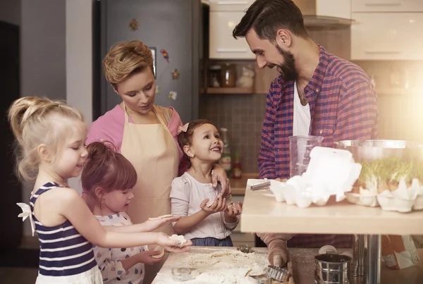 Family baking cookies in kitchen