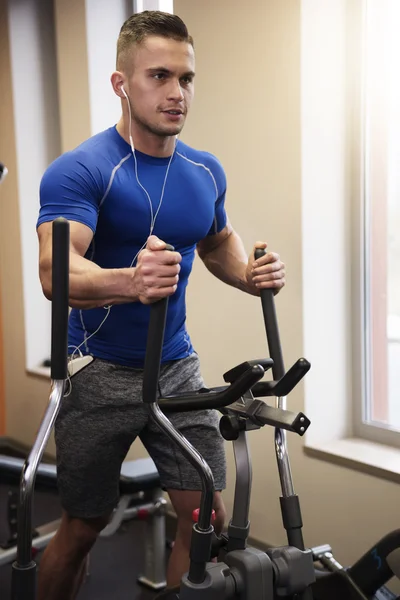 Man exercising on elliptical trainer