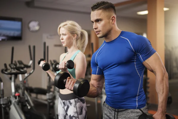 Couple working out with dumbbells