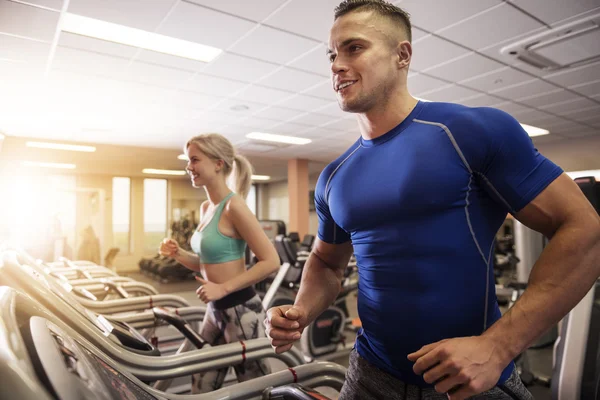 Couple working out together at the gym