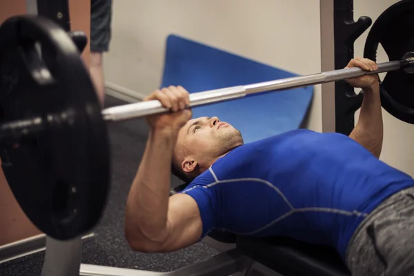Man doing workout on weight bench