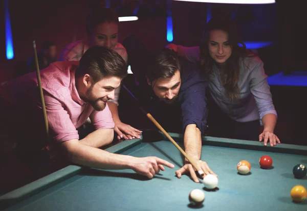 Friends playing pool game