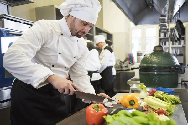 Chef chopping fresh vegetables