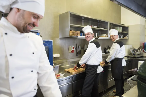 Chefs chatting while preparing food