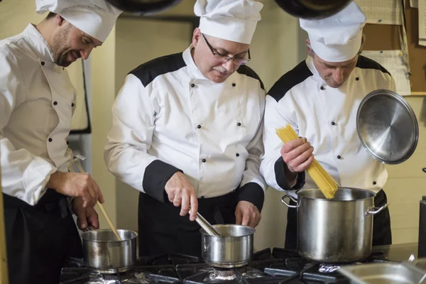 Chefs working together in commercial kitchen