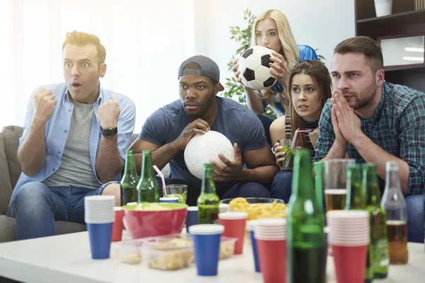 Friends watching football match